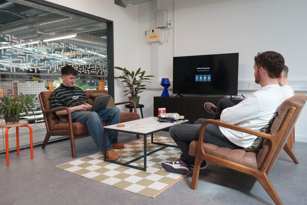 The lab dressed as a living room, with a sofa and TV