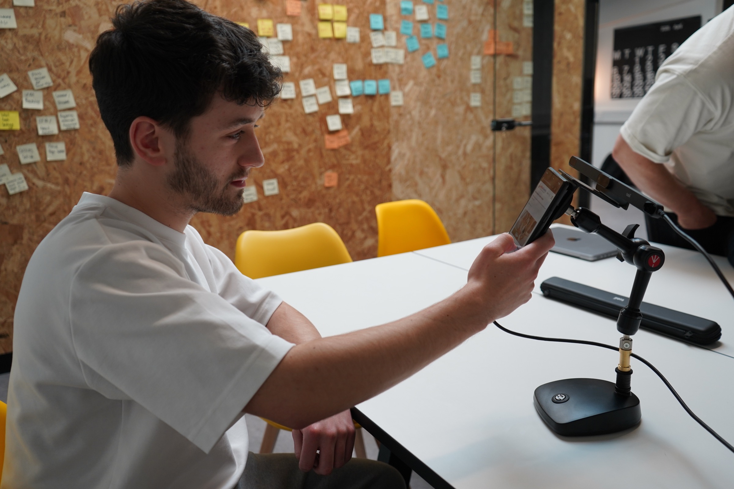 Participant testing a mobile site on the phone rig in the lab